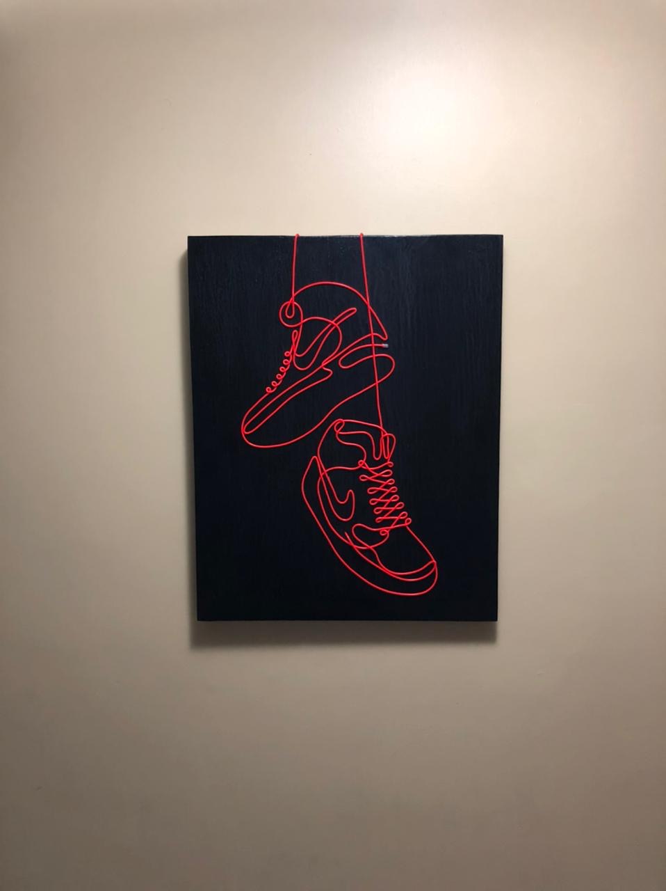 Cuadro Trazo 01 en rojo neón · tenis colgando